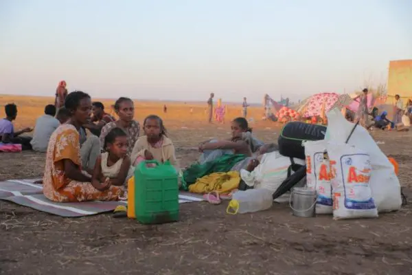 Ethiopian refugees rest and prepare food.