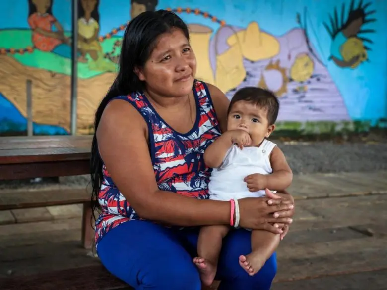 A mother holding her baby.