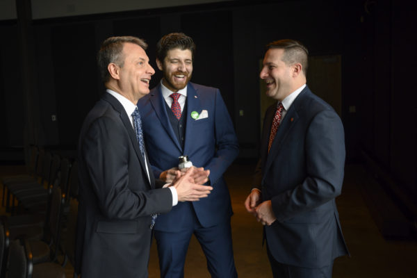 Tareq Hadhad, centre, a Syrian refugee and founder of Peace by Chocolate, laughs with Michael Casasola, left, UNHCR Canada Officer in Charge, and Marco Mendicino, Minister of Immigration, Refugees, and Citizenship Canada following Hadhad's Canadian citizenship ceremony at Pier 21 in Halifax, Nova Scotia on Wednesday, January 15, 2020