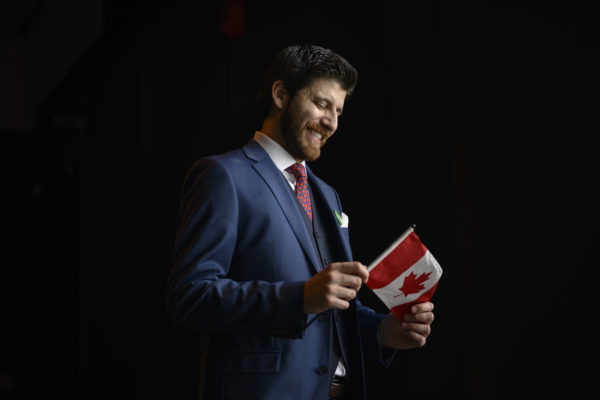 Tareq Hadhad, a Syrian refugee and founder of Peace by Chocolate, poses with the Canadian flag he received following his Canadian citizenship ceremony at Pier 21 in Halifax, Nova Scotia on Wednesday, January 15, 2020