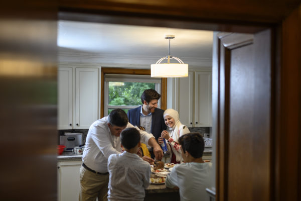 Tareq Hadhad, centre, shares a moment with his sister Taghrid Hadhad, second from right, while making the Nightingale's Nest (ÔIsh El Bulbul) dessert with his father Isam Hadhad, left, and his brothers, Omar Alkadri, second from left, and Ahmad Hadhad at their home in Antigonish, N.S