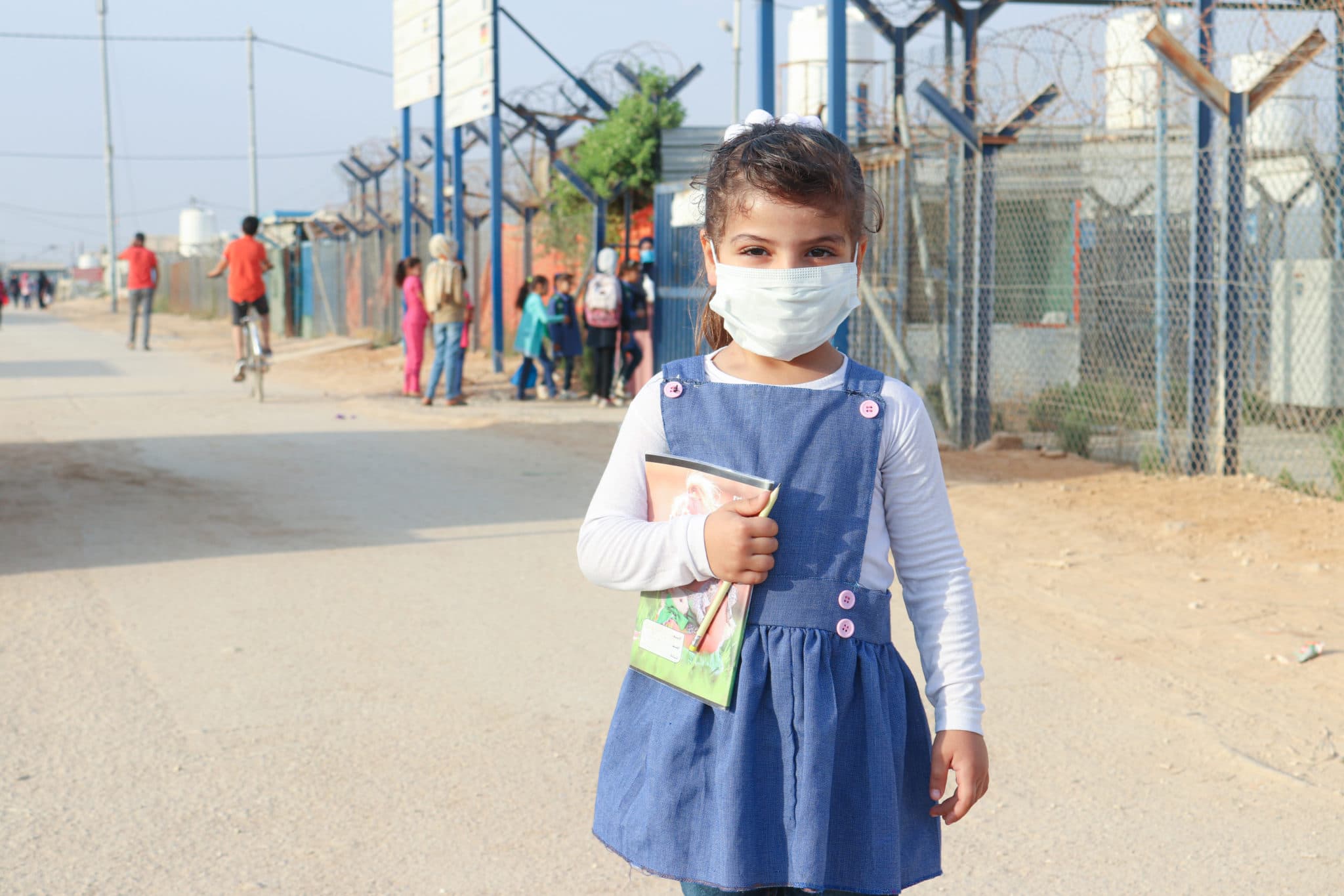 A Syrian refugee girl returns to school to receive an education
