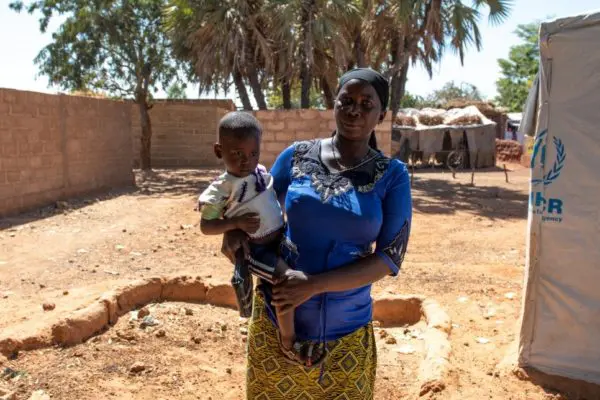 Mother holds child.