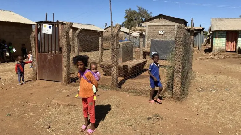 Children wait in front of a closed water station in Adi Harush refugee camp in northern Ethiopia.