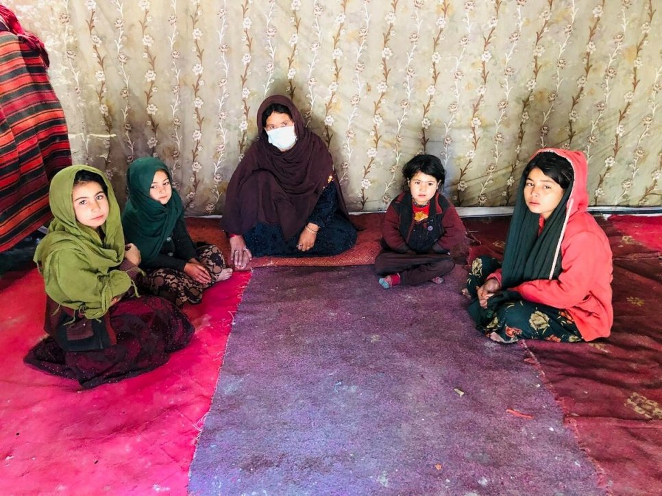 Chinar Gul with four of her five children seated on carpeted floor.