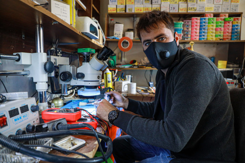 Man works with electrical equipment.