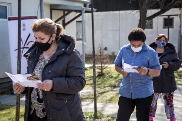 Residents at an asylum centre wait for a vaccination against COVID-19.