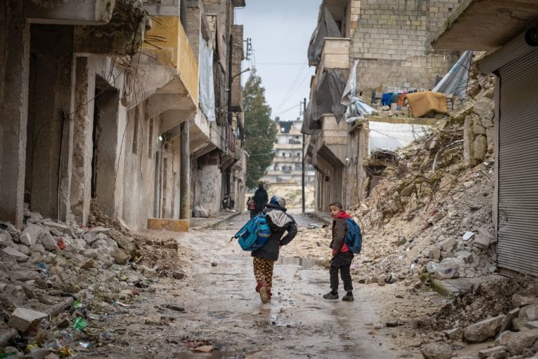 Children walk through Syria