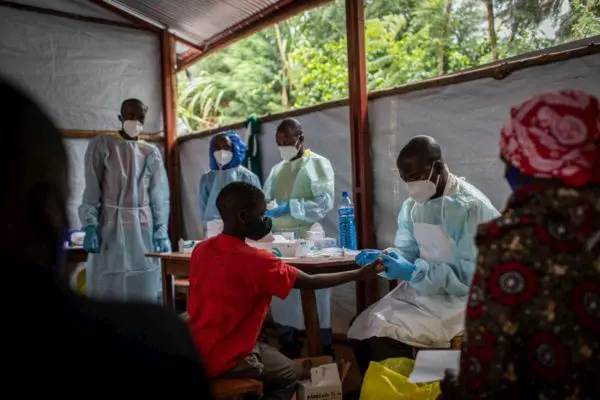A returning refugee receives a COVID-19 test.