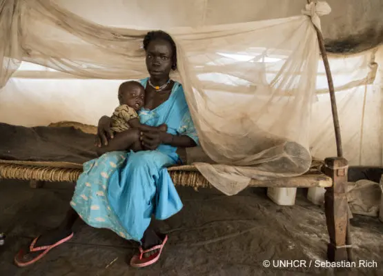 Mother holds her baby.