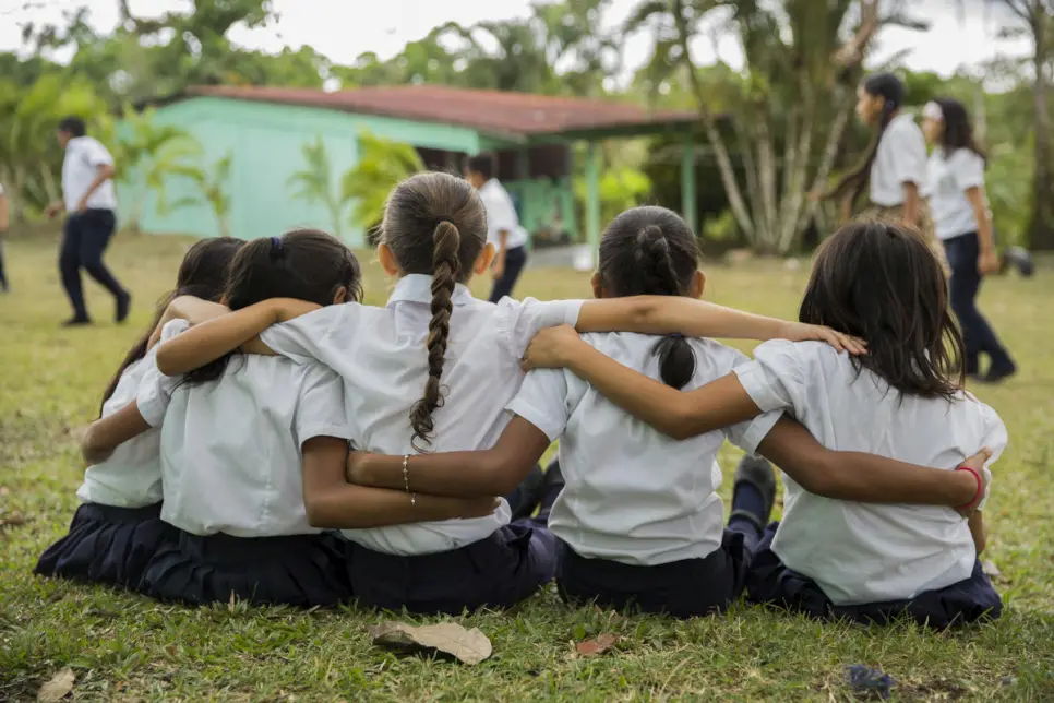 Nicaraguan and Costa Rican schoolgirls in a group hug.