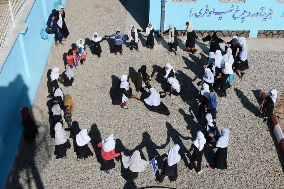 Displaced Afghan schoolgirls play during a break.