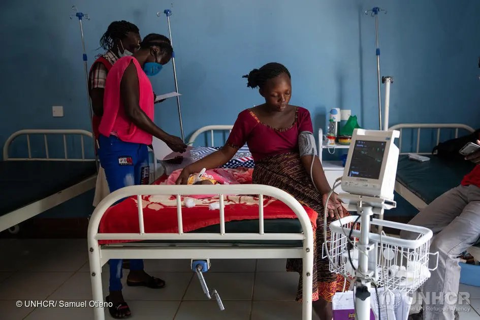 A health worker attends to 23-year-old Burundian refugee, Ishimagizwe Eliana, after she delivered her baby.