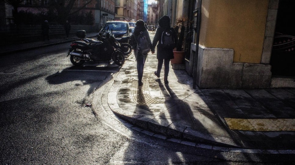 An LGBTI couple who fled violence in Latin America, walk hand in hand down the streets of their new home.