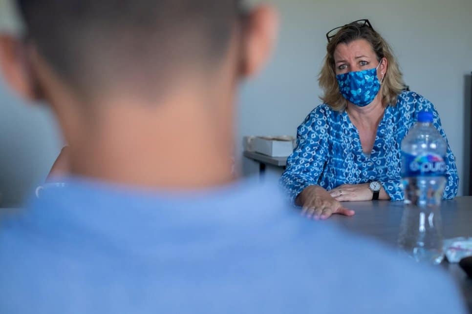  Kelly T. Clements speaks with a young Honduran asylum-seeker.