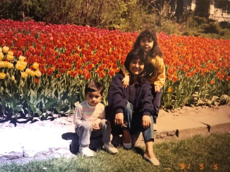 Lucila Cabrera (centre) sits beside her then five-year-old son Alex (left) and her then six-year-old daughter Erla (standing, right) at the Tulip Festival in Ottawa on May 5, 1991
