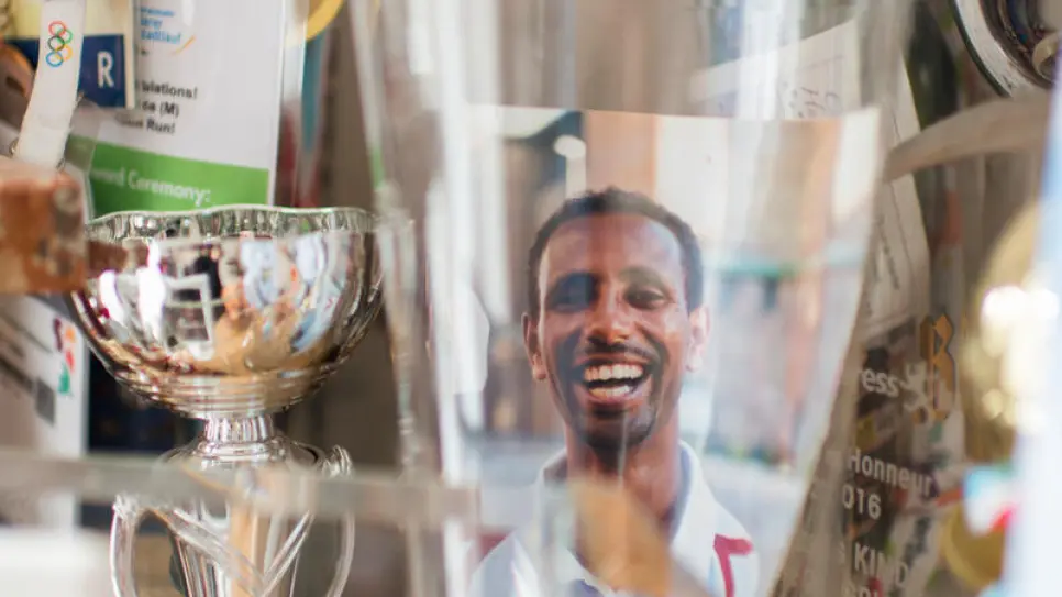 Yonas with his collection of running trophies. “I am really missing my competitions.”