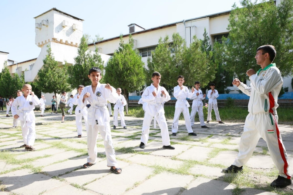 Refugee and local pupils give a Taekwondo demonstration at a school in Vahdat city, Tajikistan.