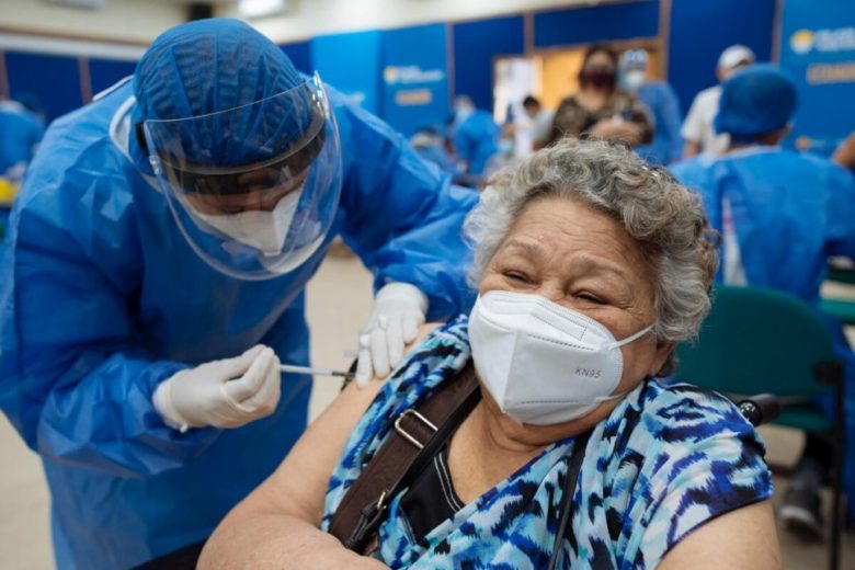Woman receives first dose of COVID-19 vaccine in Ecuador.