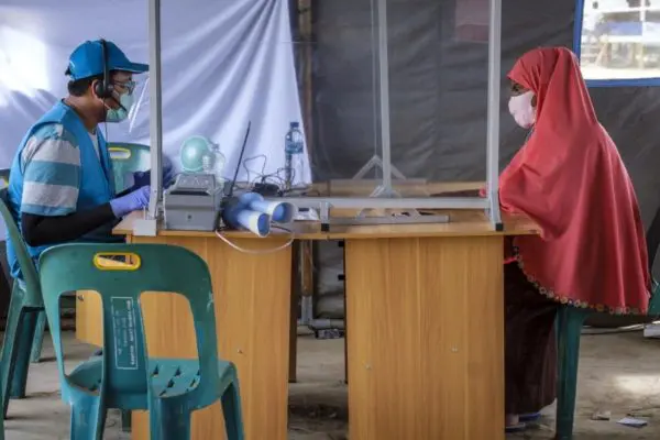 A Rohingya refugee from Myanmar is registered by a UNHCR staff member.