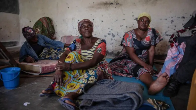 Woman seated inside their shelter.