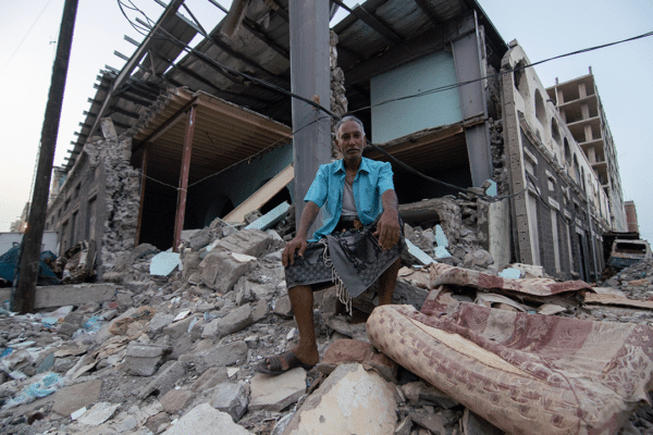 52-year-old Shaker Ali sits in front of what used to be a marketplace in Aden