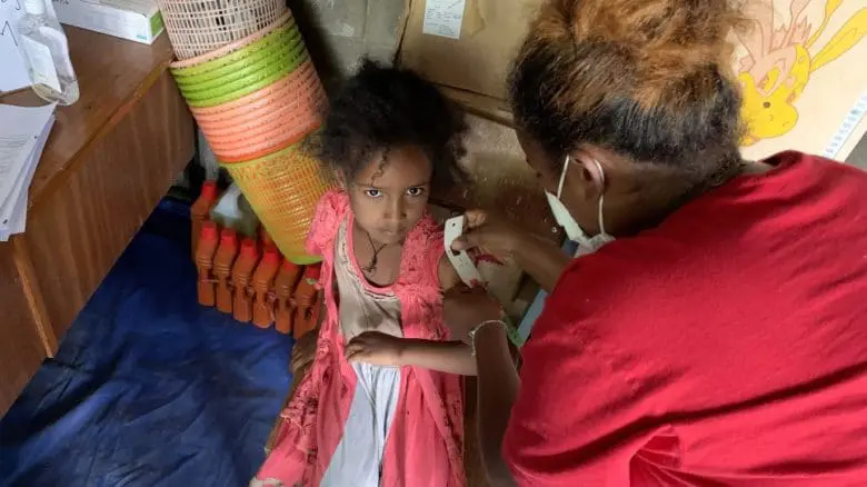 girl being helped by nurse