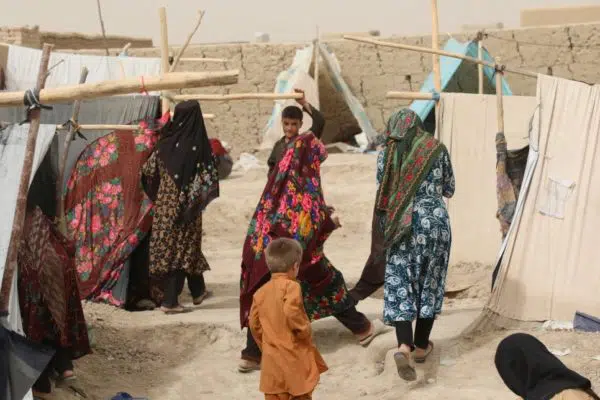 women and children going around their shelter