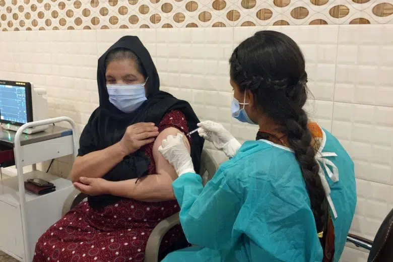 Nafeesa, 48 year old an Afghan refugee woman getting vaccinated for COVID-19 vaccination at the at the Red Crescent Mass Vaccination Centre in Rawalpindi, Punjab