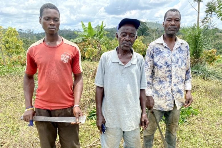 three men standing with tools