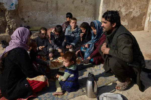 Ibrar Hussain* and his family share a meal of bread