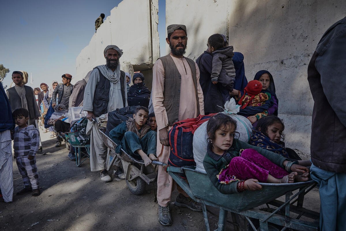 Afghans queue to enter Pakistan at the Spin Boldak border crossing on 12 December