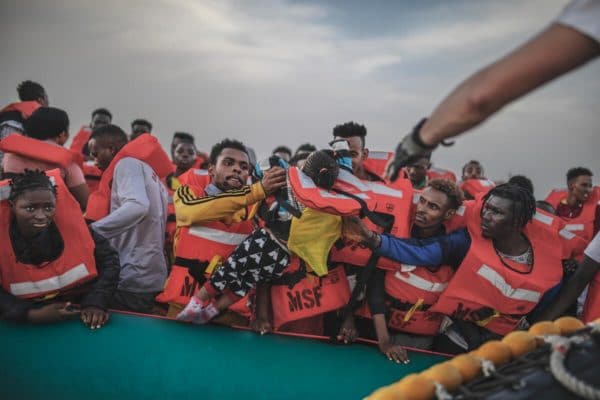 A rescue team from Médecins Sans Frontières (MSF) evacuates people from an inflatable boat in the Libyan search-and-rescue zone of the Mediterranean on 23 October