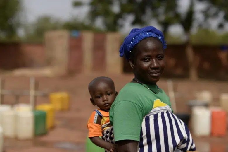 Woman carrying her child on her back.