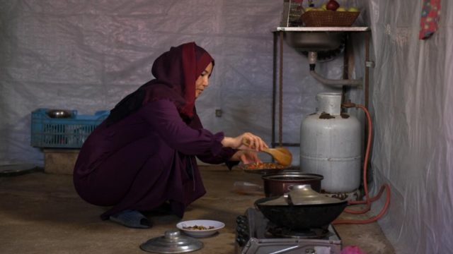 woman kneeling and taking food