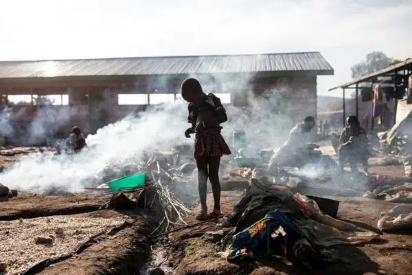 Congolese child in front of smoke from fire