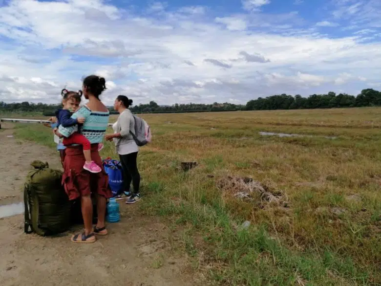 A refugee family is talking with a UNHCR staff member.