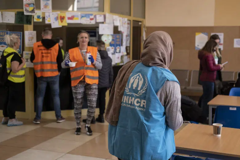 UNHCR Staff in blue UNHCR jacket working in waiting room in Poland