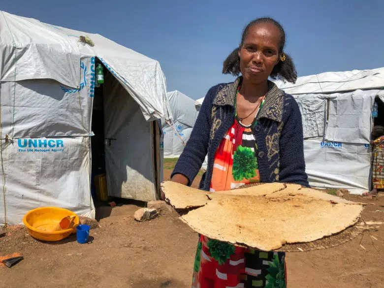 Woman holding freshly baked bread.