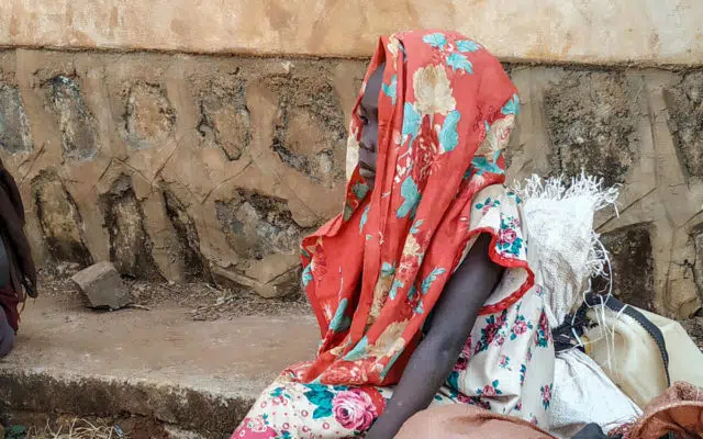 A girl is wearing a headscarf in an Ethiopian refugee camp.