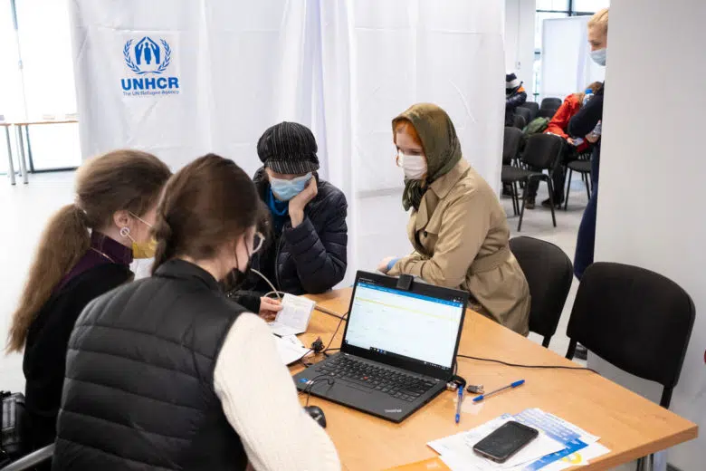 Group of people at a registration desk.