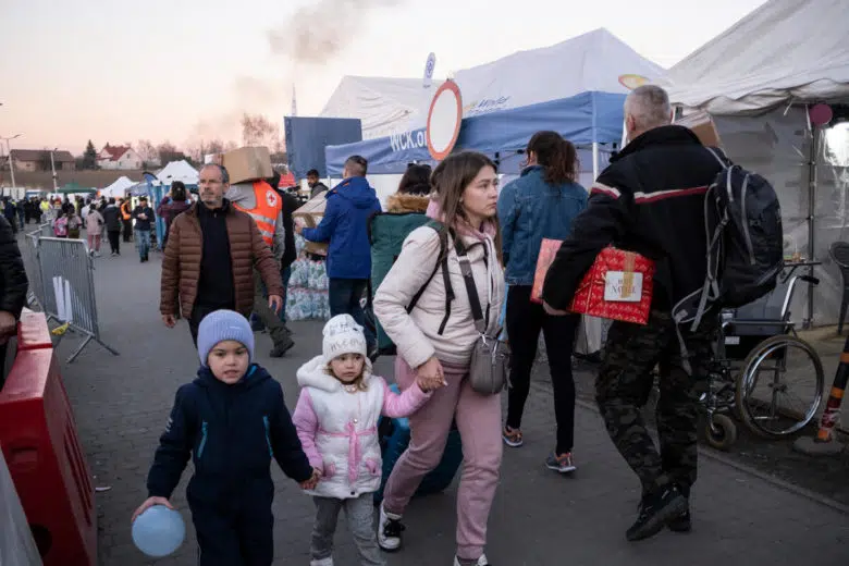Ukrainian refugees arriving at a Polish border crossing.