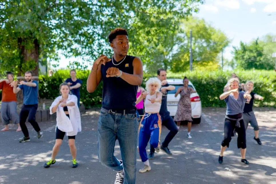 group of people dancing in a parking lot