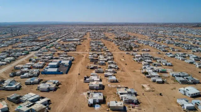 Aerial view of shelters on dirt ground