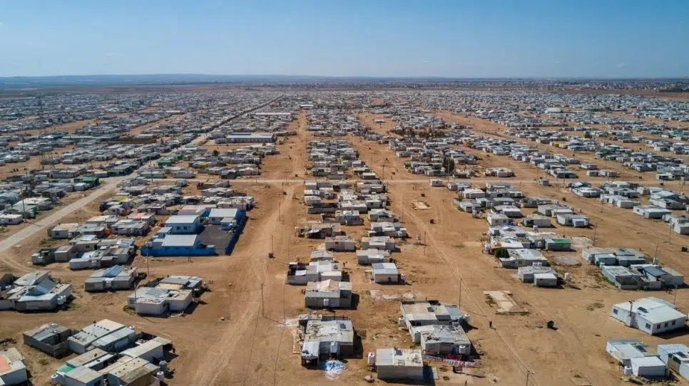 Aerial view of shelters on dirt ground 