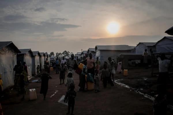 sunsetting over a refugee camp that is still busy with people