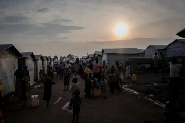 sunsetting over a refugee camp that is still busy with people
