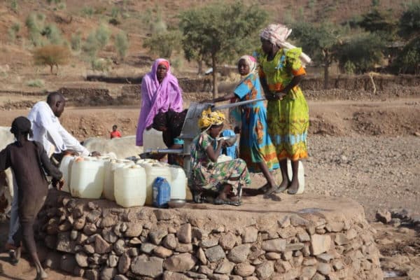 Internally displaced people gathered by a well in Sudan