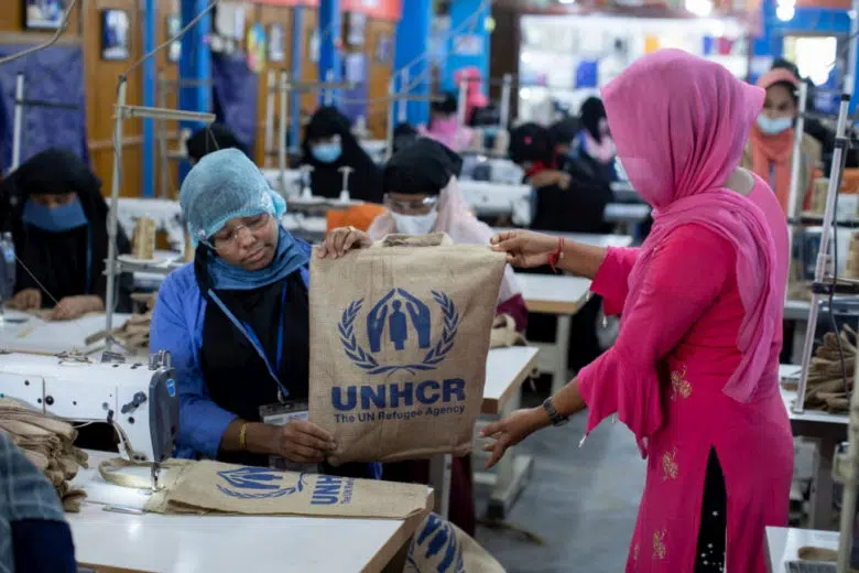 Rohingya women make jute bags with UNHCR logo on them