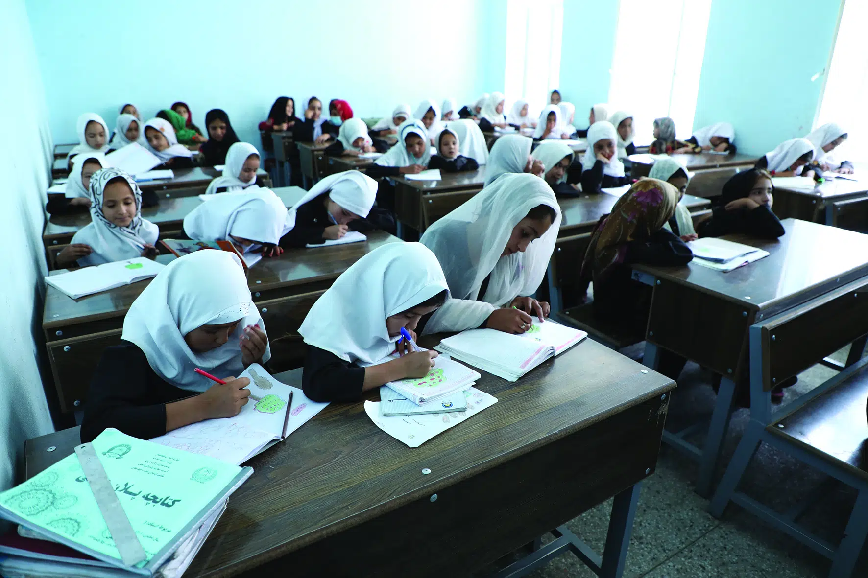 A group of internally displaced Grade Three pupils draw during art class. The Kahdistan Primary School was built by UNHCR in 2020.